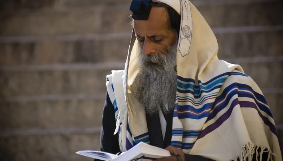 A devout Messianic Judaism man deep in prayer.