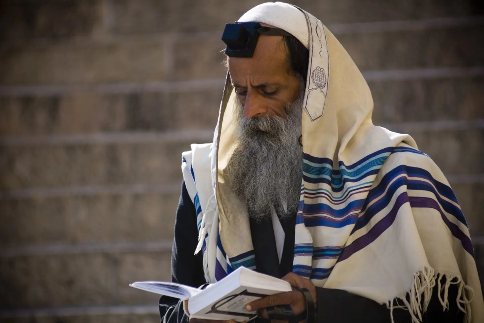 A devout Messianic Judaism man deep in prayer.